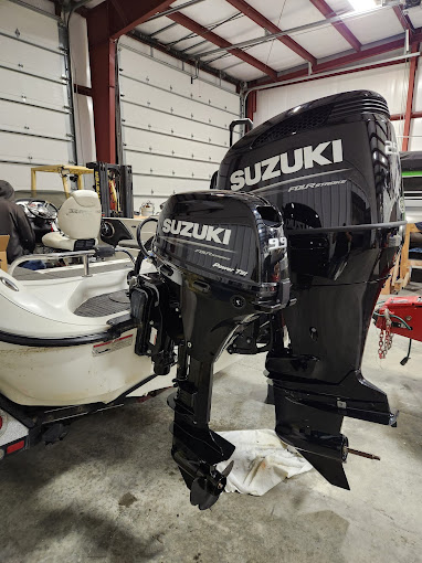Red and black SeaArk fishing boat on the water