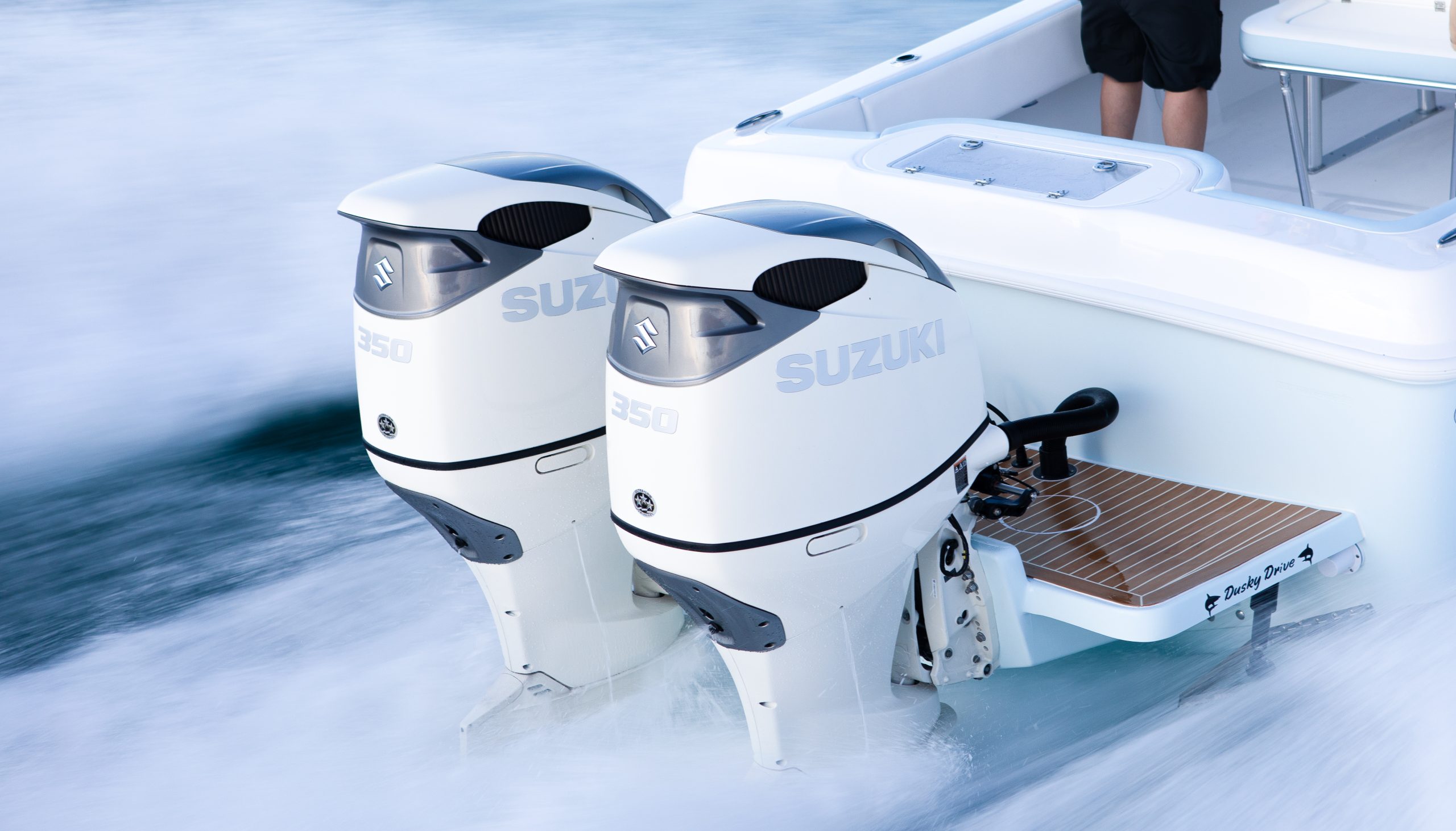 Twin Suzuki DF350A outboard motors mounted on a Dusky boat
